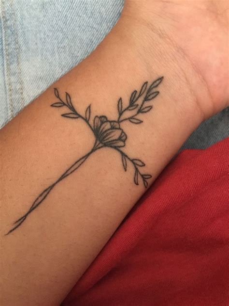 A lovely cross tattoo on wrist of a girl. Wrist tattoo - sprig - floral tattoo - cross tattoo ...
