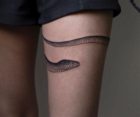 Snake tattoo on the back. Snake Tattoos | Band tattoo, Snake tattoo meaning, Feet ...