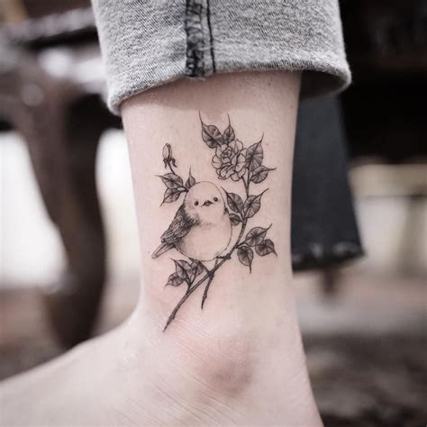 Its meaning is similar with the sparrow tattoo as well. small bird and flowers tattoo idea | Bird and flower ...