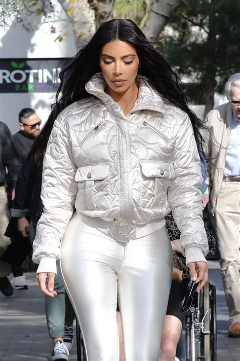 Even as a little peek a boo, kim's butt still steals the show. Kim Kardashian in Shiny White Leggings 03/20/2019 • CelebMafia