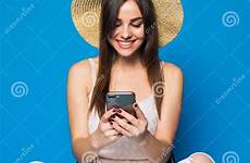 typing chilling pretty woman hair long hat chair phone background blue