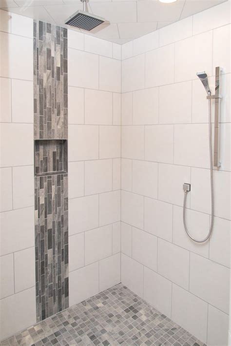 White bathroom floor tiles with small black insets can effectively ground the floor space, keeping it distinct from white walls. White Tiled Shower: Warm Grey Tiled Accent | Shower tile ...