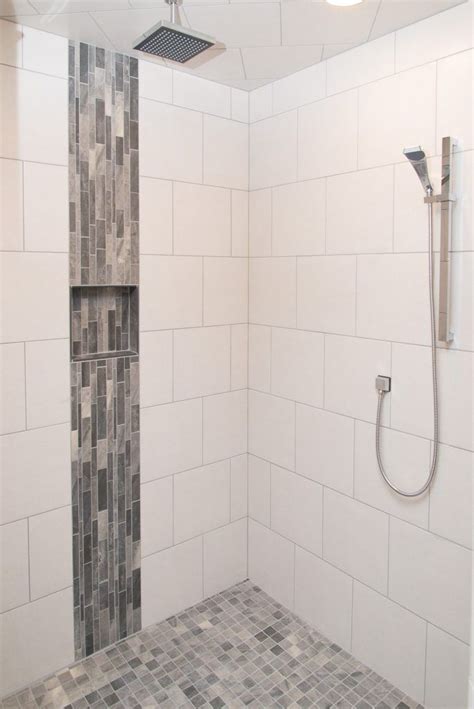 Terracotta and subtle pinks make for one of the best bathroom tile design ideas. White Tiled Shower: Warm Grey Tiled Accent | Shower tile ...