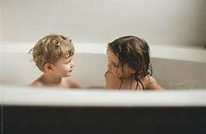 sister brother bath time talking during stocksy perfect