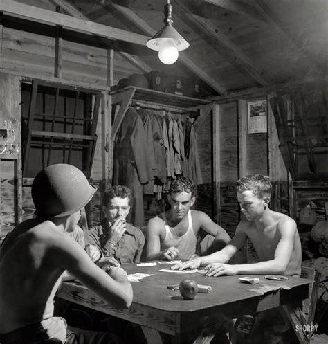 Another card is dealt to the remaining player(s) face up. Men of the 25th Service Group play five card stud in their barracks, 1943. From the Office of ...