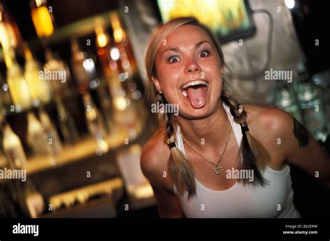 A young woman in a bar showing off her pierced tongue in Ground Zero ...