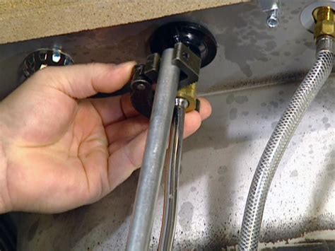 Hold the valve body in place with one pair of pliers, and loosen the compression nut on the supply tube with the other pliers. How to Install a Single-Handle Kitchen Faucet | how-tos | DIY