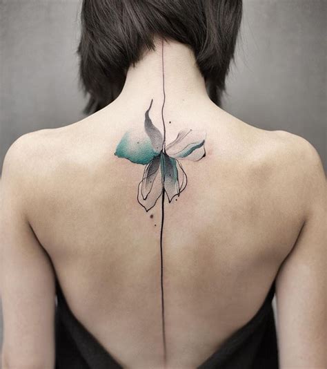 This beautiful flower tattoo is perfect for spine tattoo. Minimalistic watercolor back tattoo 🌸 by @chenjie ...