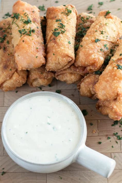 To roll the egg roll, pull the corner closest to you up towards the center of the filling and wrap it under the filling. Blue Cheese Buffalo Chicken Egg Rolls - Cake 'n Knife