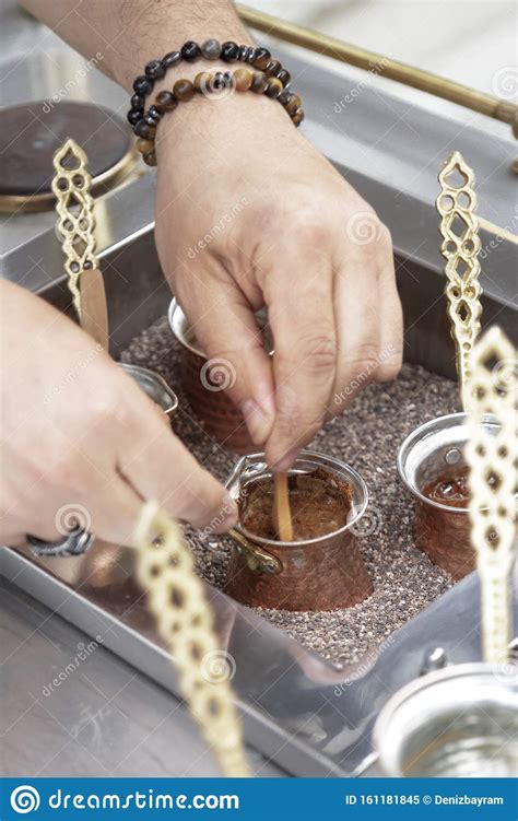 The best way to make turkish coffee involves sand. Close Up View Of Turkish Coffee Prepared On Hot Golden ...