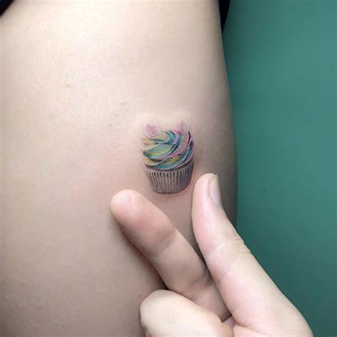 If you want something realistic, then ask a tattoo artist to make a 3d cupcake tattoo with a marsala cherry on the shoulder. Cupcake by Ray #thightattoos | Tiny tattoos, Cupcake ...