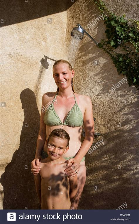 Dishes piled in the sink, laundry all over the living room, the beef for dinner still in a frozen. Mother and son in shower Stock Photo: 281002342 - Alamy