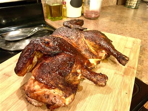 Spatchcock chicken on the Weber kettle, half with Carolina mustard 