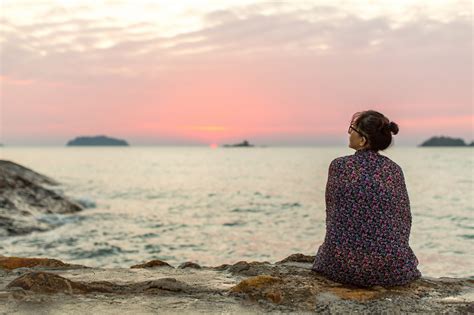 Lonely woman sitting on the seashore after sundown. - Bladder Cancer ...