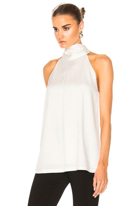 Skimpy white satin blouse on a flawlessly beautiful brunette. GALVAN SATIN SLEEVELESS TIE-NECK BLOUSE, IVORY, WHITE | ModeSens