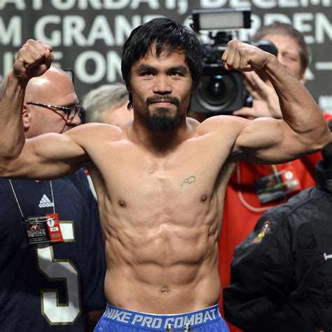 Manny pacquiao (l) and wba welterweight champion yordenis ugas face off during a news conference at mgm grand garden arena on august 18, 2021 in las vegas, nevada. manny pacquiao