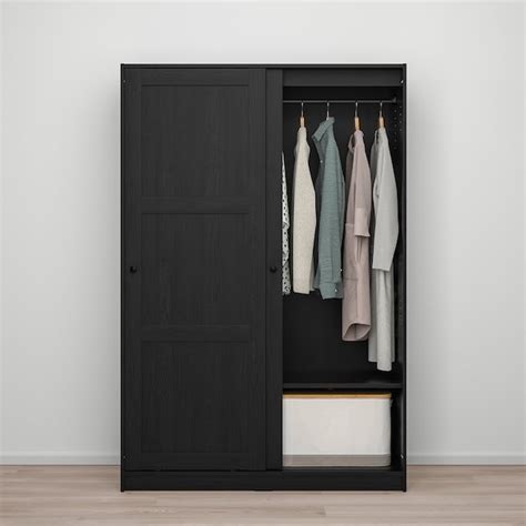 How to install a sliding door technology for furniture in bedrooms: RAKKESTAD Wardrobe with sliding doors - black-brown - IKEA