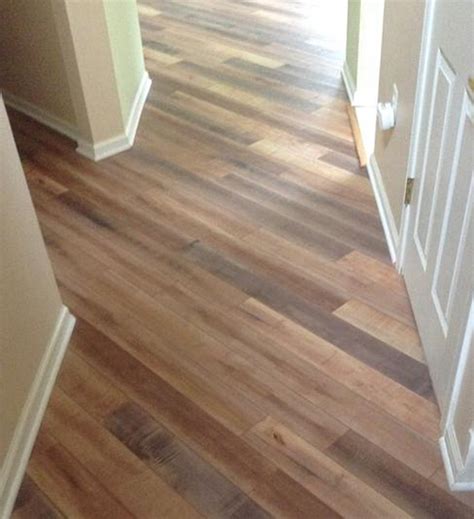 This hardwood transition strip is shaped to make smooth transition from a lower vinyl floor upward to a thicker ceramic or stone tile floor. What Does Transition Pieces Look Like When Installed With ...