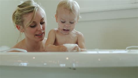 It holds even the tiniest babies in the water without submerging them entirely. Mother and Baby Taking a Stock Footage Video (100% Royalty ...