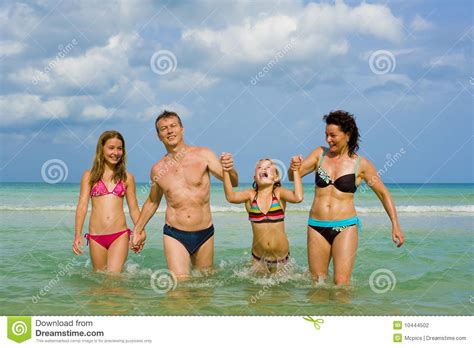 On late winter days, when the spring is closer and closer, with every more and more confident sun ray, every lighter and longer evening, people's hearts are awaken with the eternal hunger of love. Family Having Fun At The Beach Stock Photo - Image of ...