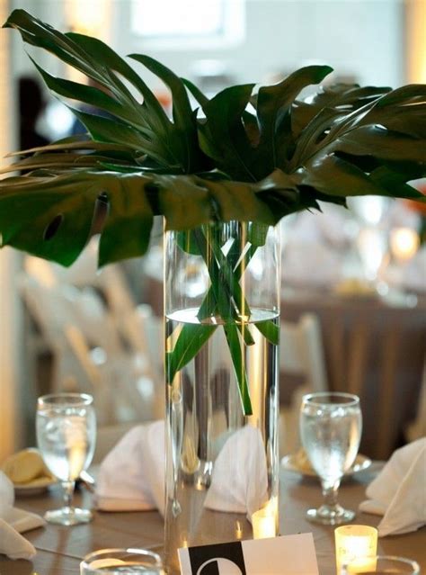 Decorate with a subtle bouquet of green leaves. LARGE MONSTERA LEAF | Tropical centerpieces, Palm leaf ...