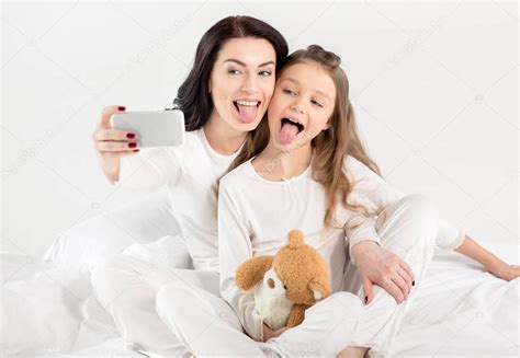 Mother and daughter taking selfie — Stock Photo © YuraSokolov #146807967