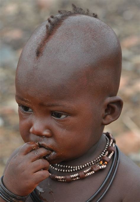 Little boy displaying his hand sculpted angry bird clay models. Africa | A little Himba boy. Epupa, Namibia | © gvst via ...