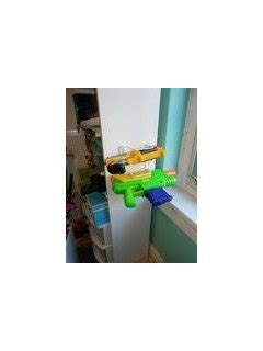 Nerf gun rack is painted in nerf colors. My brilliant wall-mounted Nerf-gun rack