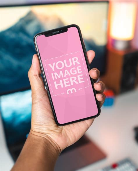 Download Man Holding iPhone X in Hand Mockup - Mediamodifier