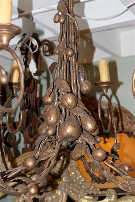 This stunningly designed, ten lamp gold and green metal chandelier is beautifully enhanced with swarovski elements® crystals. Six Light Ironies Gilt Metal Fruit Chandelier at 1stdibs