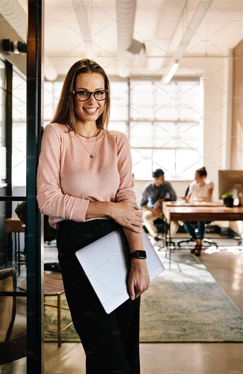 Smiling young woman leaning | Business portraits woman ...