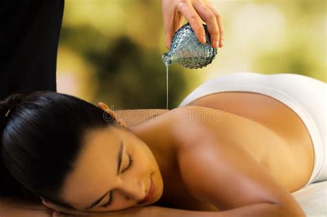 The massage for the head and for the entire body should be with the open part of the hand rather than with the fingertips. Pouring Massage Oil On Woman Back At Spa Stock Image ...