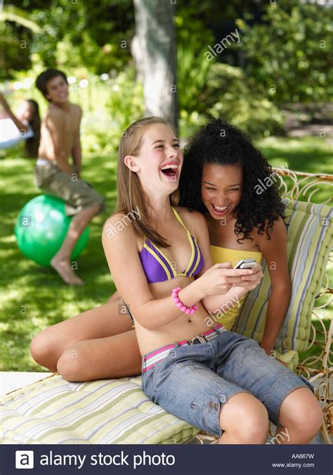 On other search engines, ads are based on profiles compiled about you using your personal information like search, browsing, and purchase history. Two teenage girls sitting outdoors in summer with cell ...