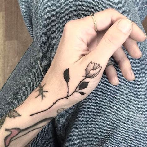 Rose tattoos have been a popular choice for people for many decades. Clean little rose on hand by Ana Neudecker. #AnnaNeudecker ...