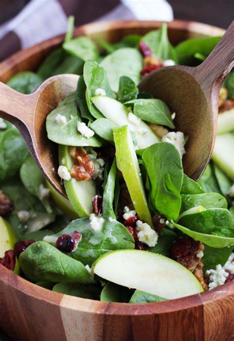 In a large salad bowl, combine the spinach, cheese, pecans and apples. Apple-Cranberry-Spinach-Salad-5 - 3 Yummy Tummies