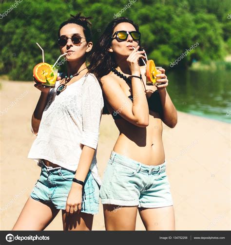 Spam comments are visible to you only, you can delete them or mark as not spam delete all. Two attractive girls hipster twins with cocktails at the ...