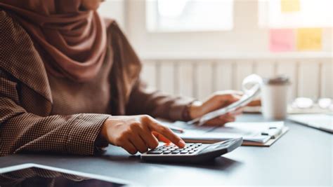 A wise malaysian man advises young adults inside, seated at a table with reading materials in the 1950s singapore. Ultimate Guide Best savings accounts in Malaysia - Wise ...