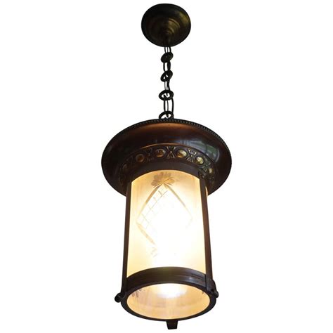 Those facing up provide ambient light. Stunning Two-Tone Brass with Hand Engraved Glass Arts and Crafts Pendant Light For Sale at 1stdibs