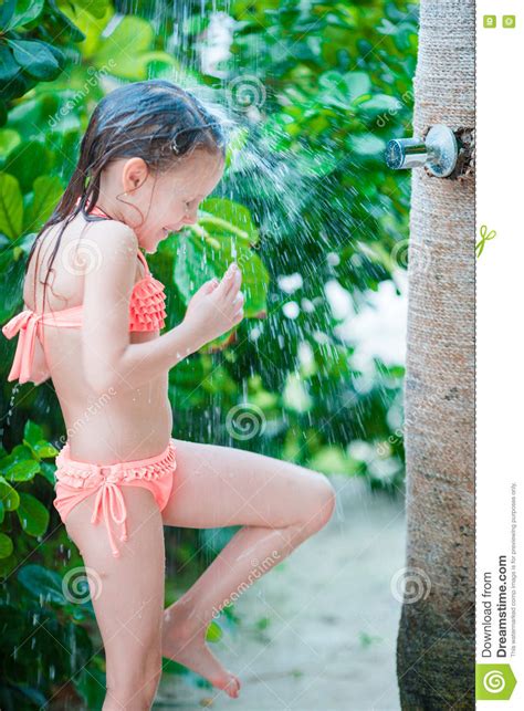 Blonde cutie under the shower. Little Happy Girl Under Beach Shower On Tropical Beach ...