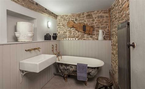 How is such a price difference even possible? exposed stone wall bathroom in traditional cottage ...