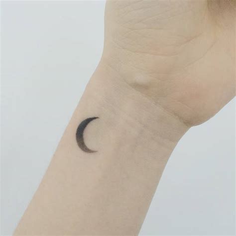 A temporary tattoo set with little moons. Minimalist style moon tattoo on the wrist.