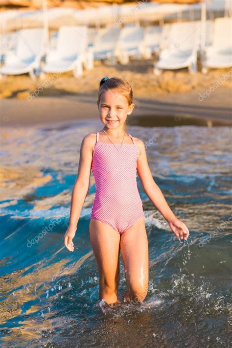Cutest girls of russian federation are streaming this very minute! Adorable happy little girl playing in the sea on a beach ...