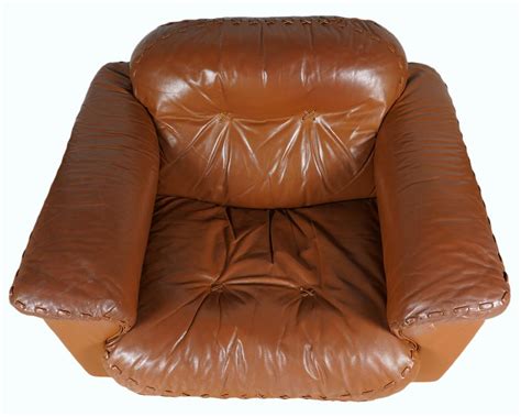 If your chair doesn't have removable covers, you can try cleaning the stain with a damp cloth. Lot - Mid Century Camel Leather Sofa & Side Arm Chair