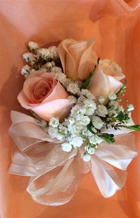 Creating stunning arrangements & bouquets. Peach Baby Roses w/ baby's breath Corsage | Spring wedding ...