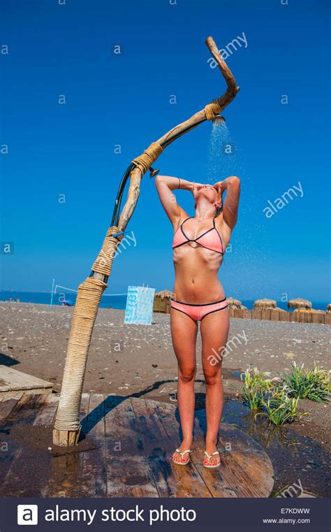 Показать другие задания этого блока. A blond girl wearing a pink bikini showers under a ...