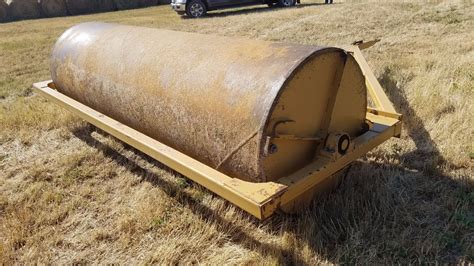 Before planting new grass seed, the lawn roller can help level uneven ground. Land Roller, 12', water filled, factory-made, good condition