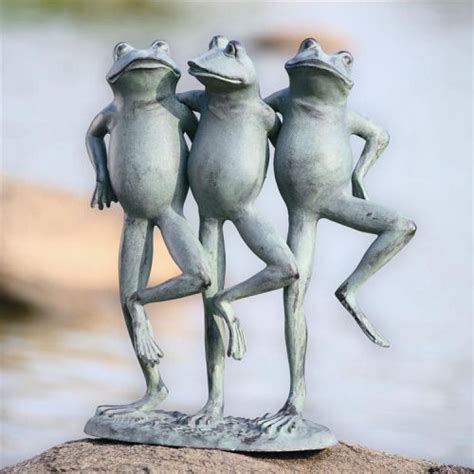 This garden statue depicts two turtles with one stacked on top of the other, and a frog on the very top. Dancing Frog Trio Garden Statue