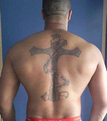 Whether an arm tattoo, chest tattoo or back tattoo. Cross & Scroll tattoo