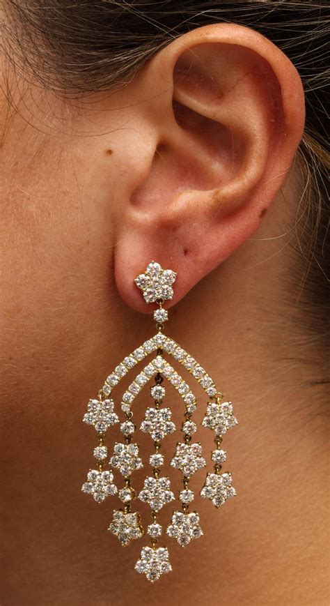 Featuring round brilliant cut diamonds weighing 5.40ct, claw set in 18ct white gold in a stylised floral design, stamped '750'. Yellow Gold Diamond Chandelier Earrings For Sale at 1stdibs