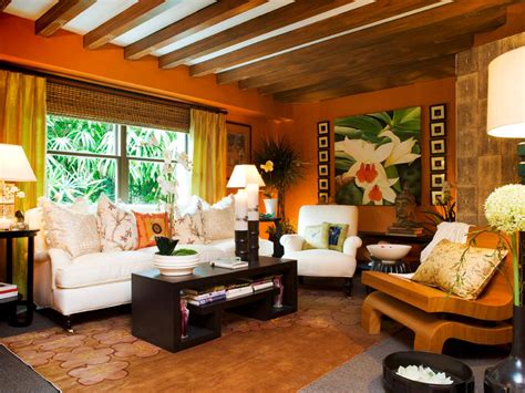 The vaulted ceiling matches the shed half to the right with faux wood beams over the exposed slats. Tropical Orange Living Room With Exposed Beam Ceiling | HGTV